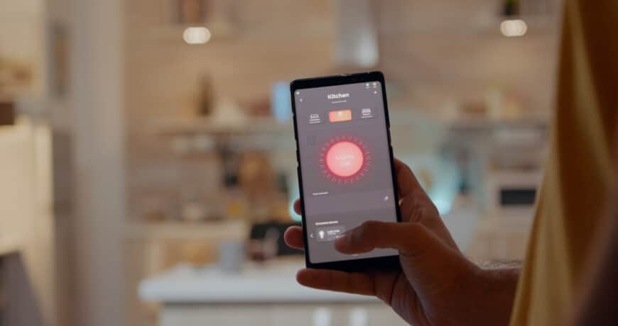 Young Man Using Smart Home Application Software Touching Screen Turn Light By Mobile Phone 870x460